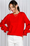 Red sweater with bows on sleeve